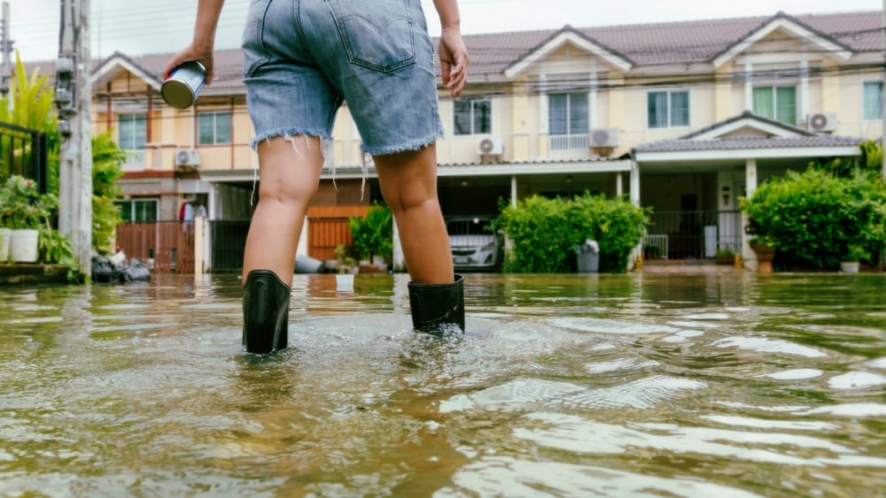 Person wading through flood waters